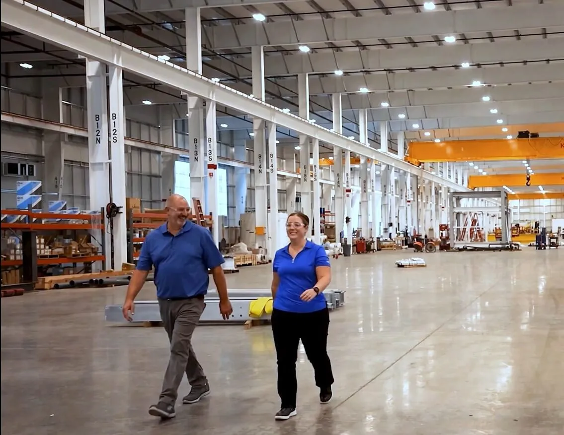 Kaylyn & Eric walk in factory inside