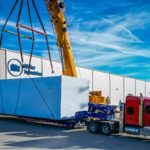 Modular unit loaded onto a semi truck at Miller Industries in Fenton, MI